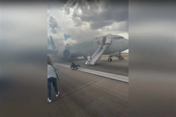 AAL plane evacuated after landing gear fire on runway